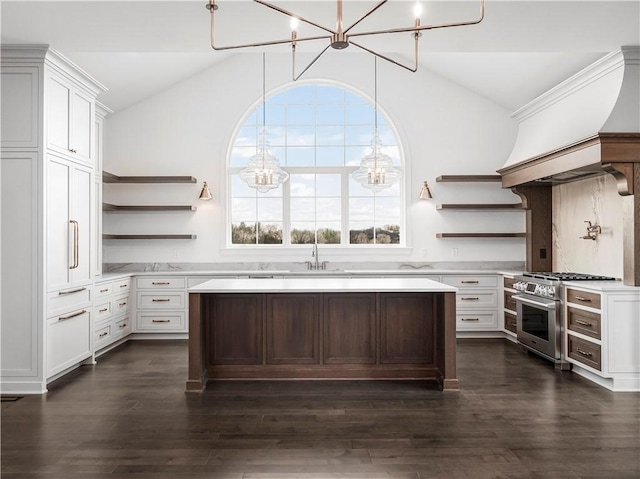 kitchen with open shelves, a chandelier, vaulted ceiling, high end range, and light countertops