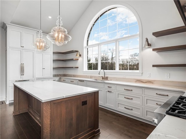 kitchen with open shelves, a sink, a chandelier, dark wood-style flooring, and white cabinets