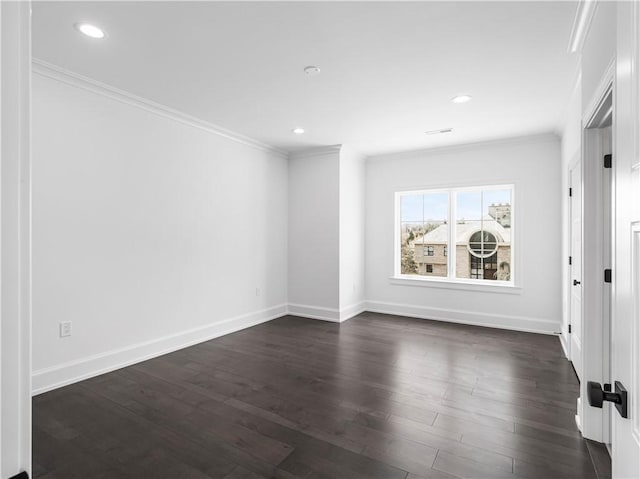 empty room featuring crown molding, dark wood-style flooring, recessed lighting, and baseboards
