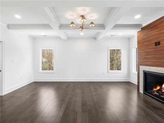 unfurnished living room featuring a high end fireplace, beamed ceiling, coffered ceiling, ornamental molding, and dark wood finished floors