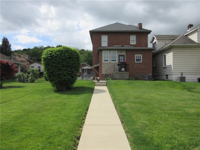 1112 Beaver Ave, Ellwood City Law, PA 16117 - back of house featuring central air condition unit, a lawn, brick siding, and a chimney
