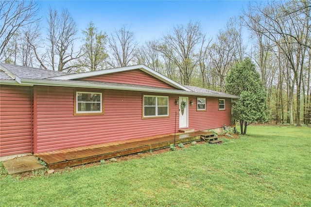 view of home's exterior featuring a lawn and roof with shingles