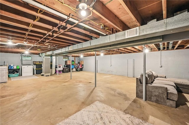 unfinished below grade area with washer / clothes dryer