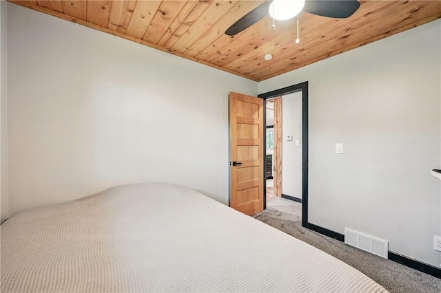 unfurnished bedroom with light colored carpet, wood ceiling, and ceiling fan