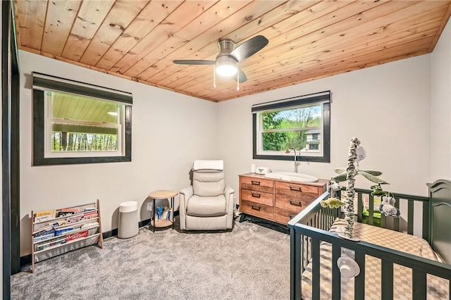 carpeted bedroom featuring wooden ceiling and ceiling fan