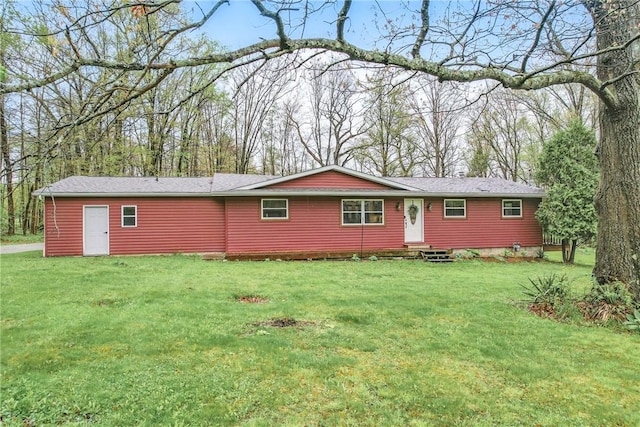 rear view of house featuring a yard and entry steps