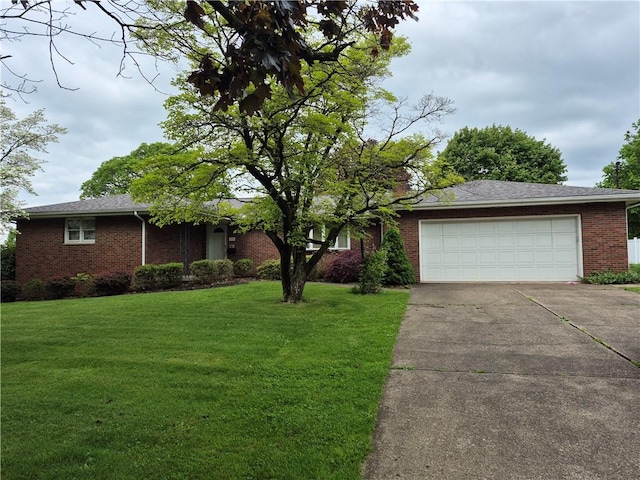 single story home with brick siding, driveway, an attached garage, and a front lawn