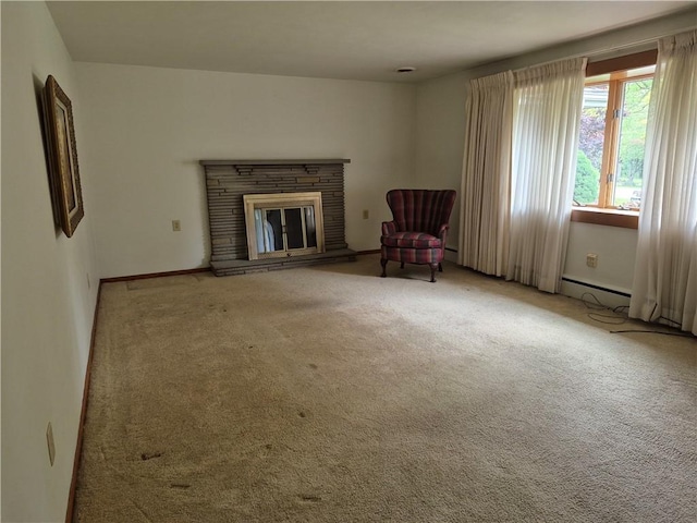 living area featuring carpet flooring, a fireplace, and baseboards