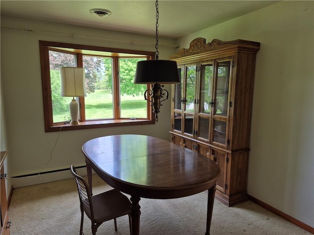dining room featuring light carpet and baseboards