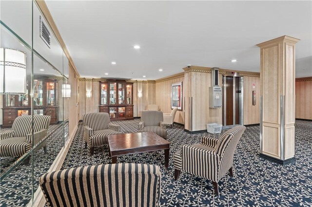 building lobby with crown molding, recessed lighting, and wood walls