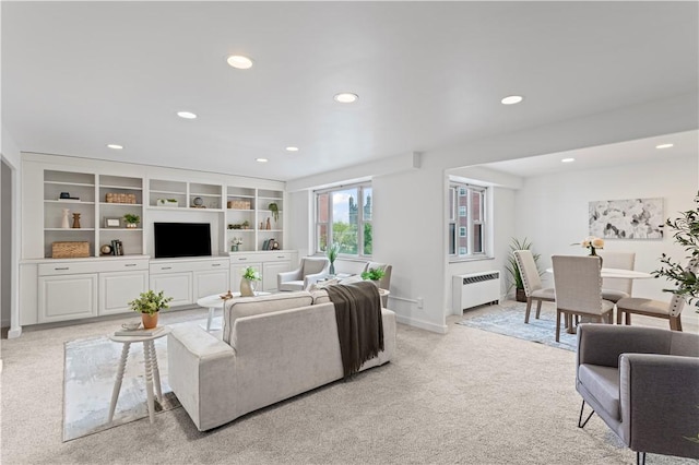 living room featuring light colored carpet, radiator heating unit, recessed lighting, and baseboards