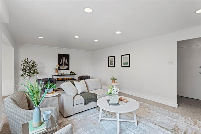 living area with light carpet, recessed lighting, and baseboards