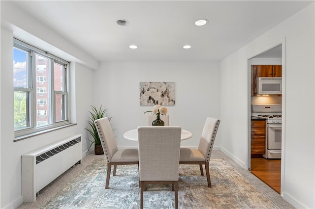 dining area featuring radiator heating unit, recessed lighting, and baseboards