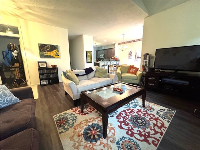 living area featuring wood finished floors, a chandelier, a textured ceiling, and baseboards