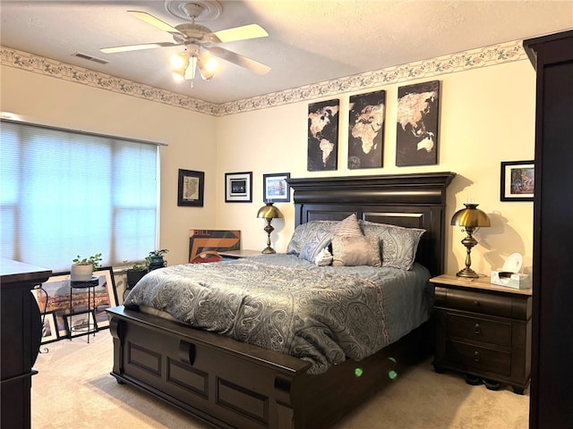 bedroom featuring light colored carpet and ceiling fan