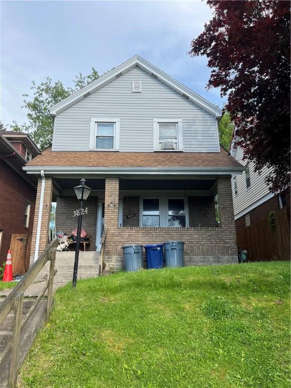 view of front facade with covered porch and brick siding