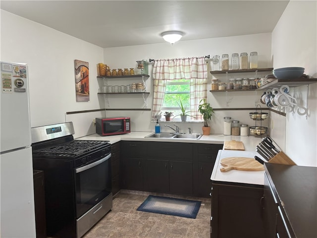 465 S 6th St, Indiana Boro Ind, PA 15701 - kitchen featuring stainless steel gas stove, freestanding refrigerator, a sink, open shelves, and dark cabinets