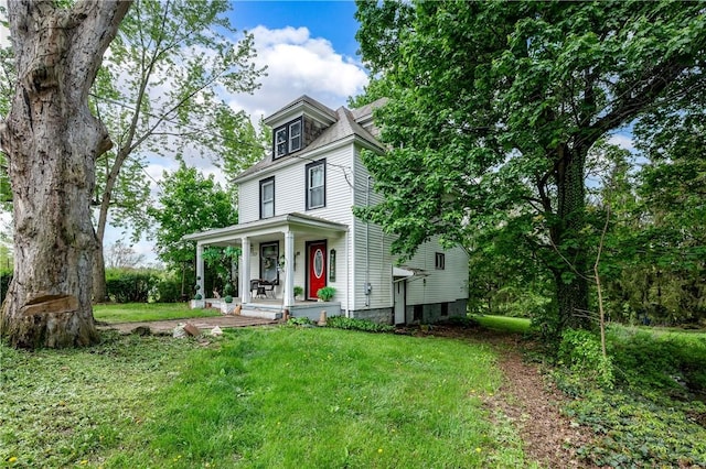 traditional style home with covered porch and a front lawn