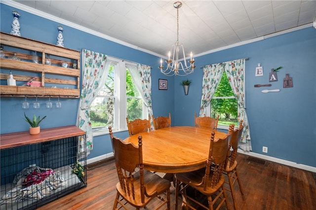 dining area featuring hardwood / wood-style floors, a chandelier, crown molding, and baseboards