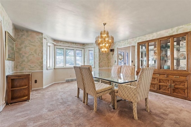 dining room with wallpapered walls, a chandelier, light colored carpet, and baseboards