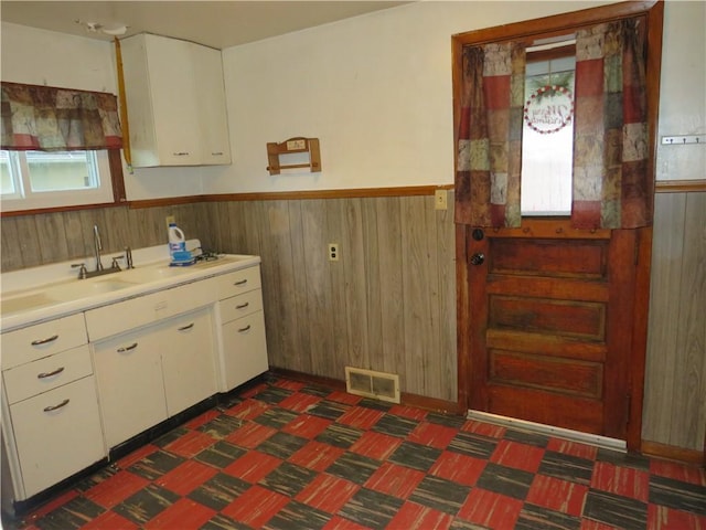1606 Oneida Valley Rd, Concord Twp, PA 16025 - kitchen with a wainscoted wall, wooden walls, white cabinets, a sink, and light countertops