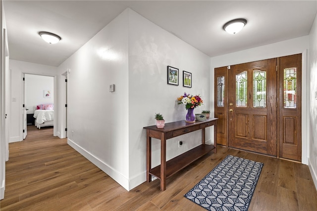 entryway featuring wood finished floors and baseboards