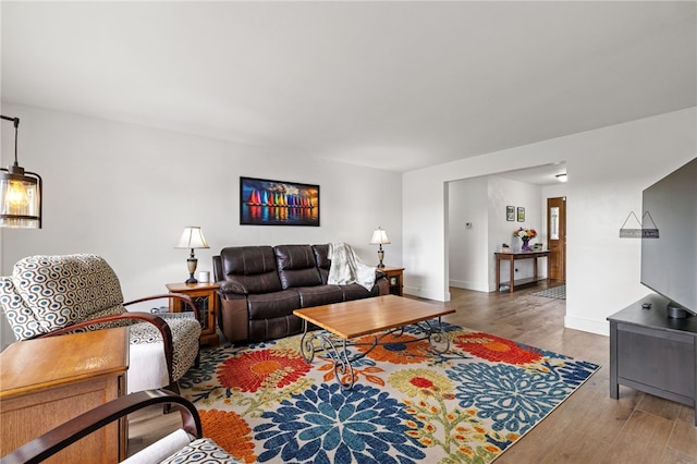 living area with wood finished floors and baseboards