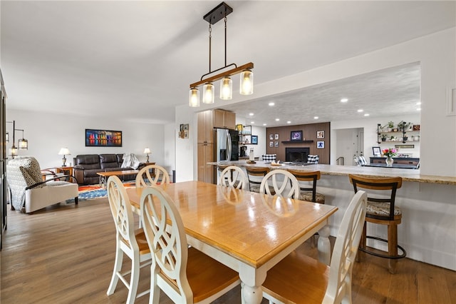 dining area with wood finished floors and recessed lighting