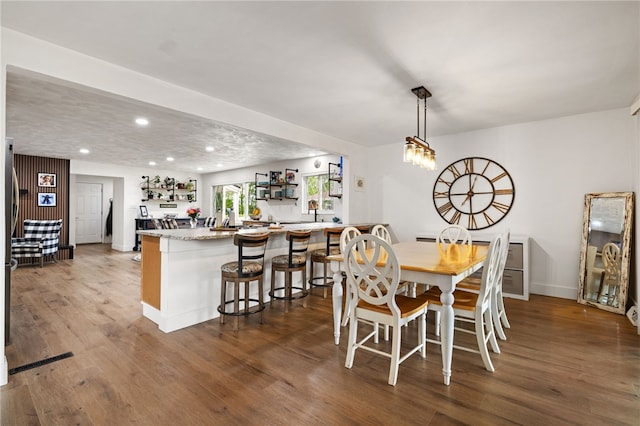 dining area with recessed lighting, wood finished floors, and baseboards