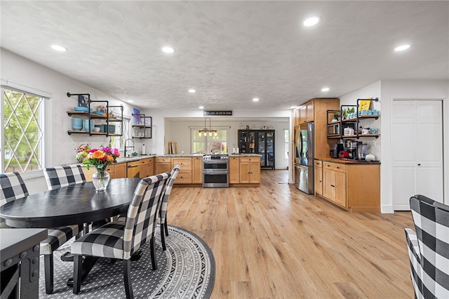 dining area featuring light wood-type flooring and recessed lighting