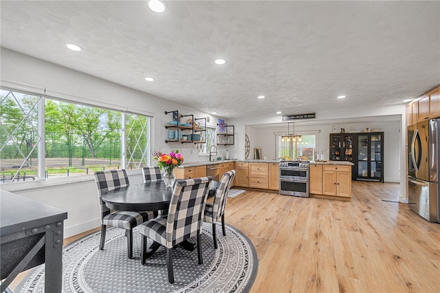 dining area featuring recessed lighting, light wood finished floors, and baseboards