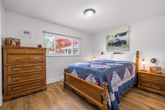 bedroom featuring light wood-style flooring and baseboards