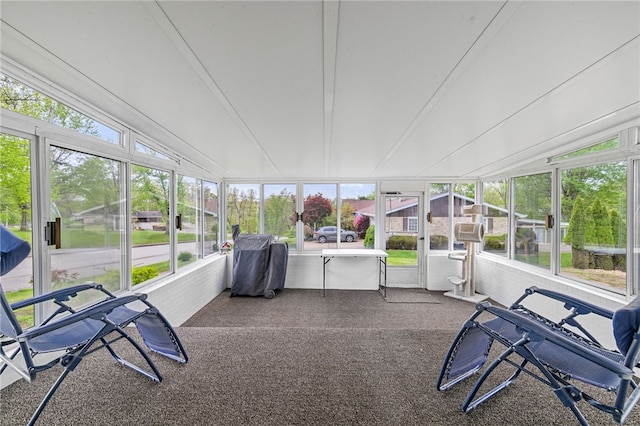 sunroom with healthy amount of natural light and lofted ceiling