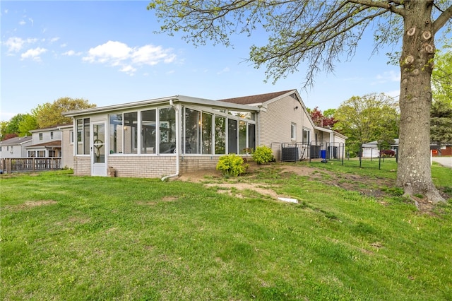 back of house featuring a sunroom and cooling unit