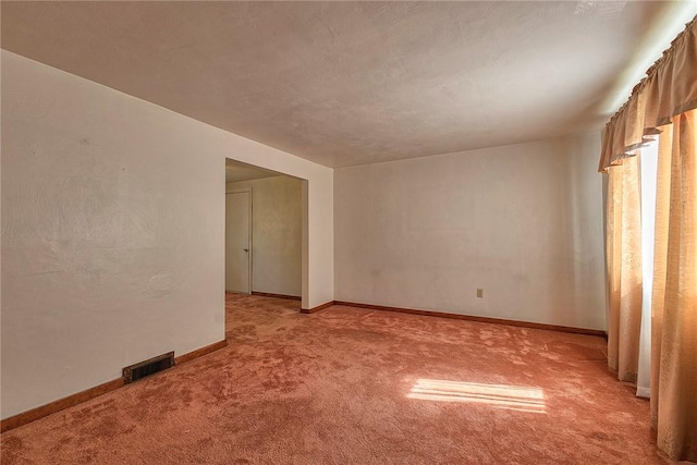 empty room with light colored carpet and baseboards