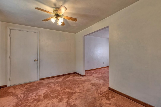 unfurnished room with carpet floors, ceiling fan, and baseboards