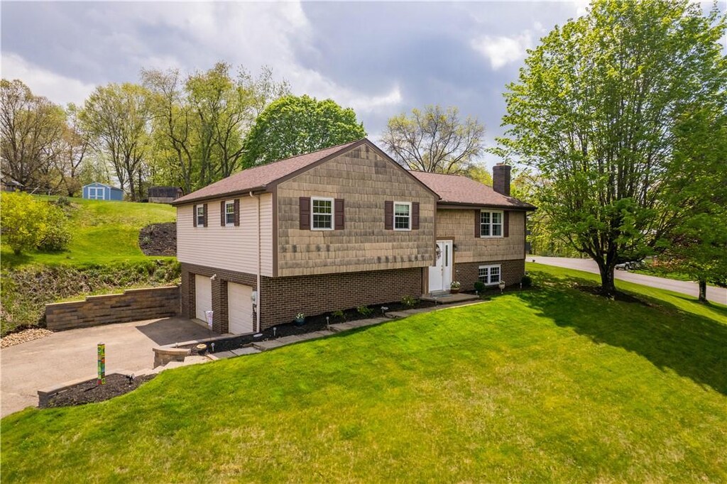 721 Brookshire Dr, Mccandless, PA 15237 - back of house with a chimney, a garage, asphalt driveway, and a yard