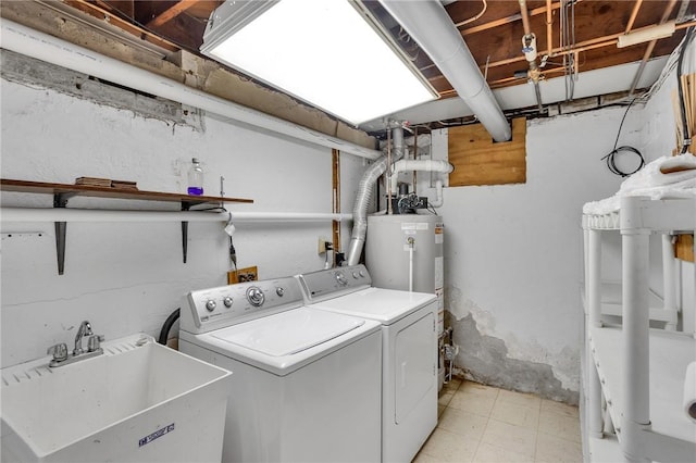 laundry area featuring washing machine and dryer and gas water heater