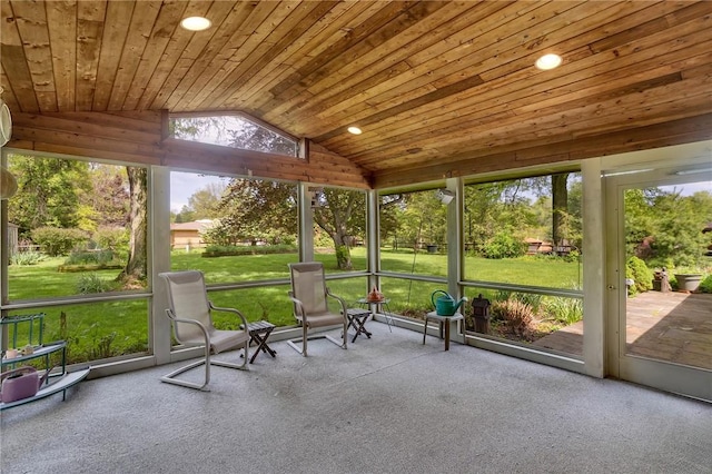 unfurnished sunroom featuring vaulted ceiling and plenty of natural light