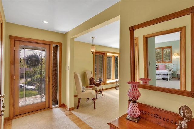 doorway featuring light wood-type flooring, baseboards, and recessed lighting