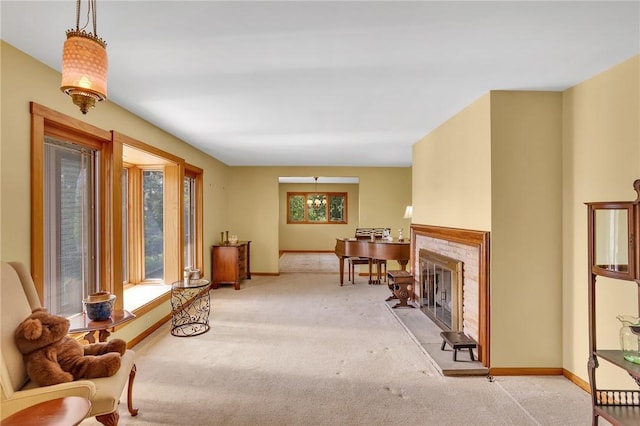 sitting room with carpet floors, baseboards, and a fireplace with raised hearth