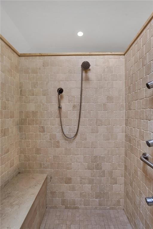 full bathroom with a tile shower and recessed lighting