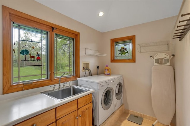 laundry room featuring washing machine and clothes dryer, cabinet space, baseboards, recessed lighting, and light tile patterned floors