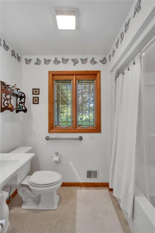 full bath featuring toilet and baseboards