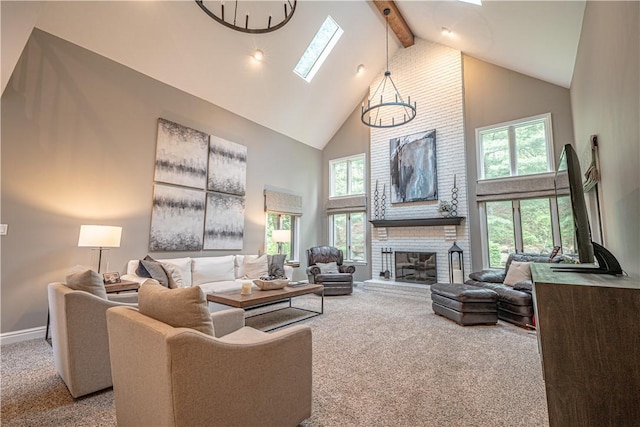 carpeted living area with high vaulted ceiling, a skylight, beam ceiling, a fireplace, and baseboards