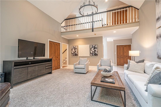 living room with high vaulted ceiling, stairs, a chandelier, carpet flooring, and baseboards