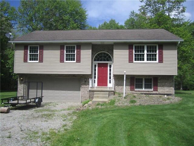 104MAPLEWOODAVE Maplewood Ave, Carmichaels/Cumblnd, PA 15320 - split foyer home featuring brick siding, an attached garage, a front yard, and driveway