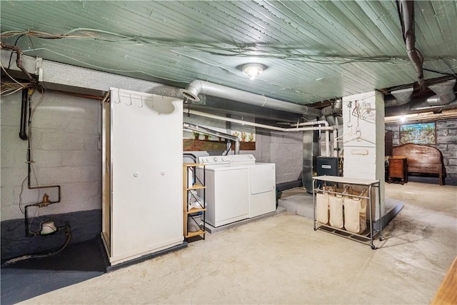 unfinished below grade area with washer and clothes dryer