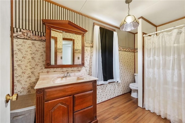 full bath with wallpapered walls, wood finished floors, toilet, curtained shower, and vanity
