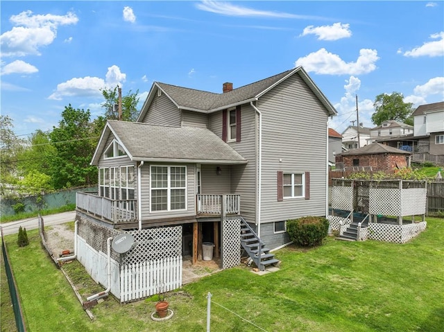 back of property with stairs, roof with shingles, a wooden deck, and a chimney